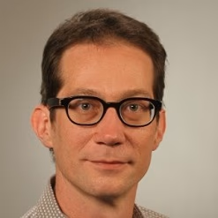 profile of Conrad Wood, man wearing glasses